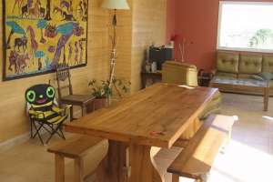 large natural wood dining table with benches